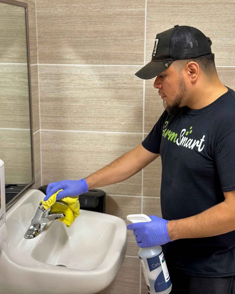 man cleaning a sink