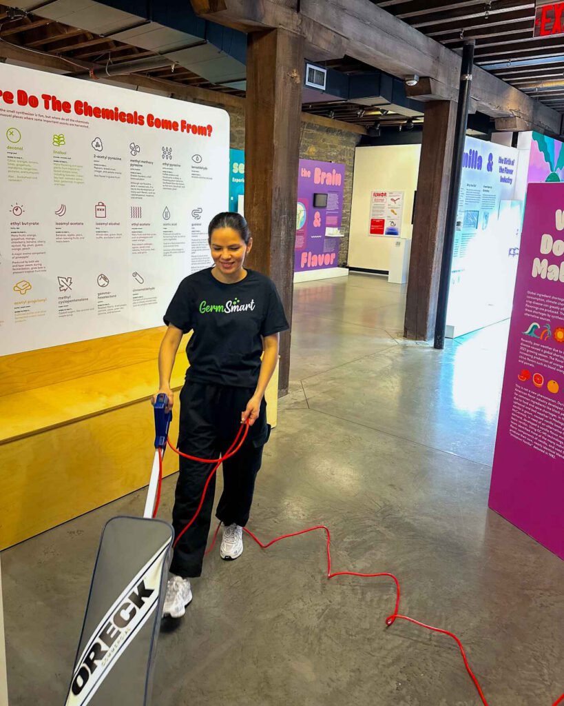 woman vacuuming floors inside a logy