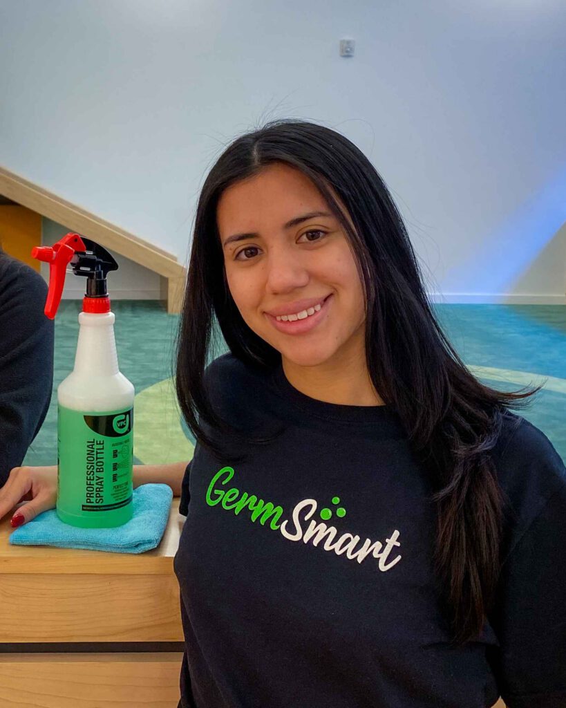 GermSmart employee cleaning a desk