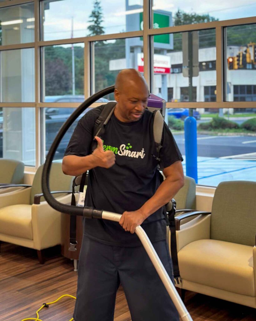 GermSmart Janitor vacuuming an office space