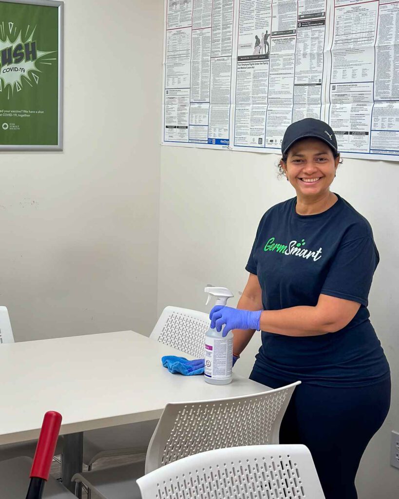 Commercial cleaning woman cleaning a desk
